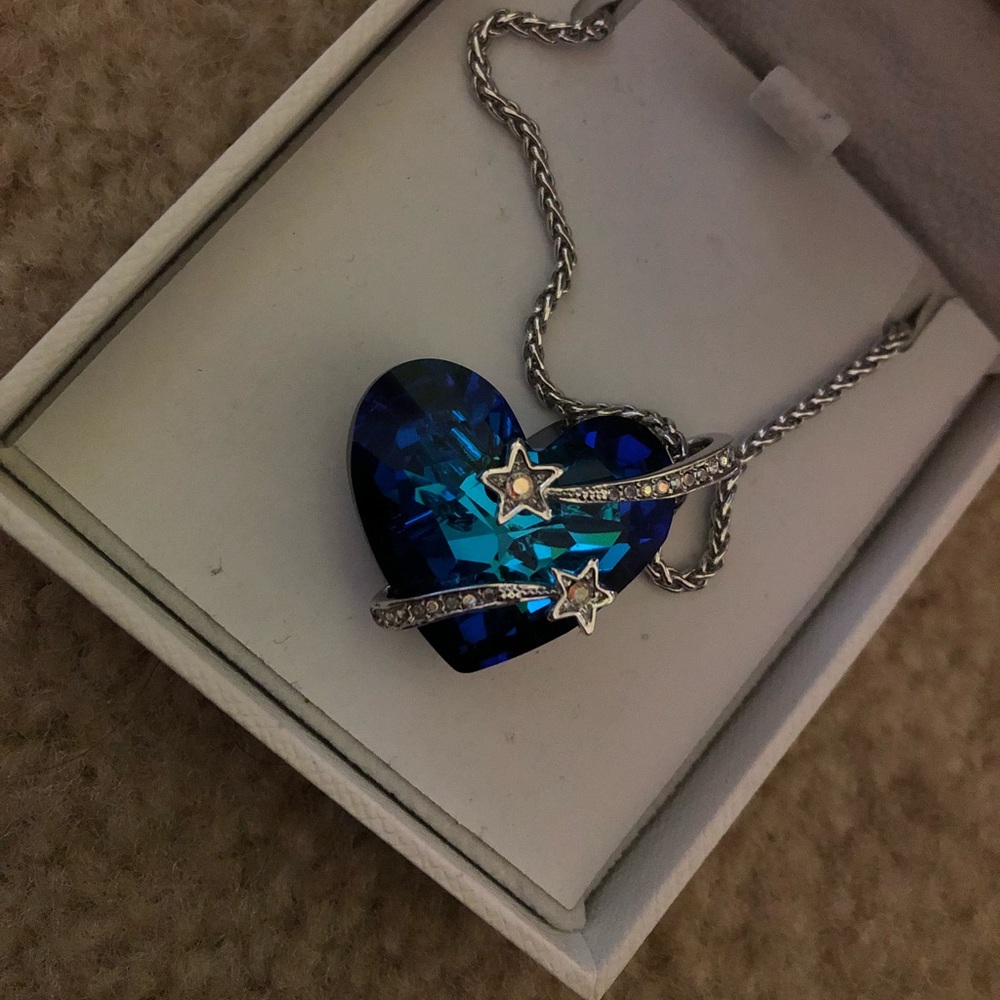 A blue stone heart necklace with detailing